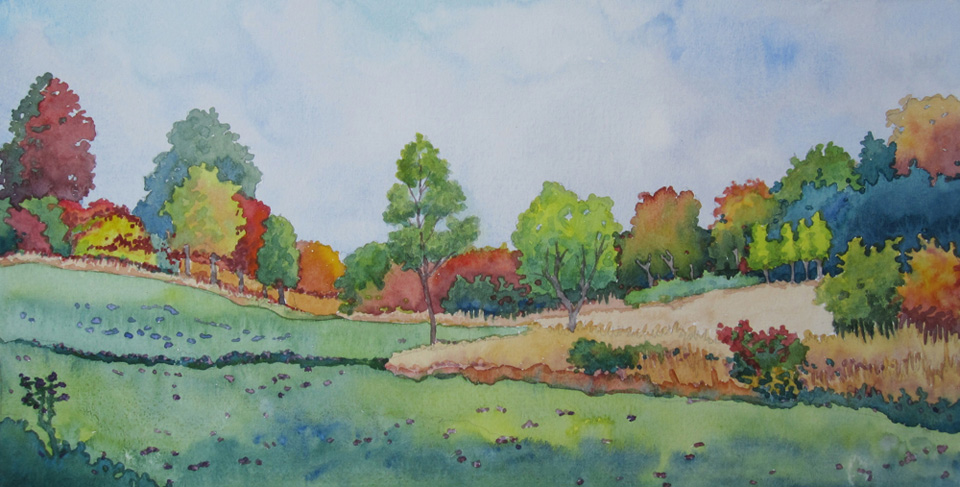 A small stream meanders through fall fields.