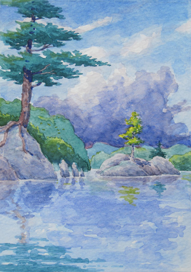 Storm clouds pass a rocky out-crop on the bay